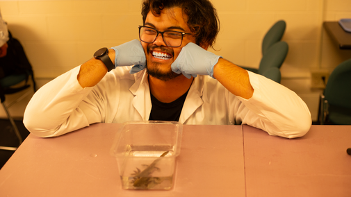 Hendy Ginting posing in front of his western tiger salamander