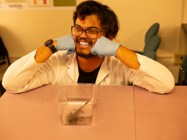 Hendy Ginting posing in front of his western tiger salamander